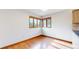Corner dining area features hardwood floors, corner windows, and plenty of natural light at 23 Carla Way, Broomfield, CO 80020