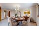 Formal dining area set with elegant dinnerware, complemented by a decorative chandelier and natural lighting at 23 Carla Way, Broomfield, CO 80020