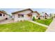 A charming home features a well-manicured lawn and a welcoming pathway, enhancing its curb appeal at 23 Carla Way, Broomfield, CO 80020