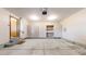 Spacious garage with ample storage cabinets, work area, and access to interior of the home at 23 Carla Way, Broomfield, CO 80020