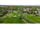 Scenic aerial view of the golf course featuring lush greenery and mature trees at 23 Carla Way, Broomfield, CO 80020
