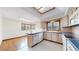 Bright kitchen features light wood cabinets, skylight, tile floor, and adjacent dining area at 23 Carla Way, Broomfield, CO 80020