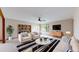 Bright living room features stylish furniture, a ceiling fan, and natural light, creating a welcoming atmosphere at 23 Carla Way, Broomfield, CO 80020