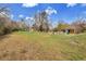 Large grassy backyard with mature trees and a patio area perfect for outdoor activities and relaxation at 4700 Homestead St, Bow Mar, CO 80123