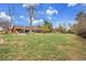 Expansive backyard with a well-maintained lawn, trees, and a patio area connected to the home at 4700 Homestead St, Bow Mar, CO 80123