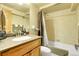 Cozy bathroom with vanity, sink, tub, shower and linen storage at 4700 Homestead St, Bow Mar, CO 80123