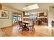 Bright and airy breakfast nook with hardwood floors, access to a deck, and seamless connection to the kitchen at 4700 Homestead St, Bow Mar, CO 80123