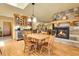 Dining area features a stone fireplace, hardwood floors, and custom built-in cabinetry at 4700 Homestead St, Bow Mar, CO 80123
