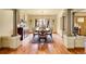 Elegant dining room features hardwood floors, classic columns, and large windows provides a perfect setting for gatherings at 4700 Homestead St, Bow Mar, CO 80123