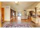Spacious living room features hardwood floors, a stone fireplace, built in shelving, and an abundance of natural light at 4700 Homestead St, Bow Mar, CO 80123