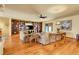 Cozy living room with hardwood floors, built in shelving, and comfortable seating offers an inviting space to relax at 4700 Homestead St, Bow Mar, CO 80123