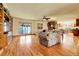 Bright living room with hardwood floors, a stone fireplace, and large windows offer an inviting atmosphere at 4700 Homestead St, Bow Mar, CO 80123