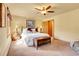 Inviting bedroom with wood furniture, soft lighting, and neutral tones at 4700 Homestead St, Bow Mar, CO 80123