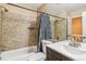 Bathroom featuring tiled walls, shower-tub combination, and vanity sink at 12059 E Hoye Dr, Aurora, CO 80012