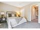 Comfortable bedroom with neutral colors, plush carpeting, and closet access at 12059 E Hoye Dr, Aurora, CO 80012