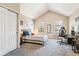 Spacious bedroom with vaulted ceilings, natural light, and neutral carpeting at 12059 E Hoye Dr, Aurora, CO 80012