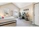 Bright bedroom features vaulted ceilings, natural light, and a dedicated desk space at 12059 E Hoye Dr, Aurora, CO 80012