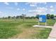 Well-maintained disc golf course with green grass and informational signage at 12059 E Hoye Dr, Aurora, CO 80012