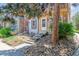 Inviting townhouse exterior with stone detailing, front yard landscaping, and a cozy entrance at 12059 E Hoye Dr, Aurora, CO 80012