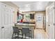 Modern kitchen featuring stainless steel appliances, granite countertops, and a breakfast bar at 12059 E Hoye Dr, Aurora, CO 80012