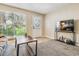 Inviting living room featuring a bright window, television, and modern decor at 12059 E Hoye Dr, Aurora, CO 80012