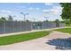 Public tennis courts with fencing and nearby green space at 12059 E Hoye Dr, Aurora, CO 80012