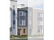 Modern townhome showcasing vertical and horizontal siding and brick facade, creating an eye-catching street view at 14279 Currant St, Broomfield, CO 80020
