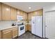Bright kitchen with light wood cabinets, modern appliances, and hardwood floors, creating a functional cooking space at 5873 Ceylon St # E, Denver, CO 80249