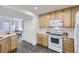 Well-lit kitchen with light wood cabinets, modern appliances, and hardwood floors, creating a functional cooking space at 5873 Ceylon St # E, Denver, CO 80249