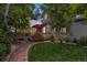 Backyard view of a well-maintained lawn, mature trees, and wooden deck with outdoor seating at 6112 Alkire Ct, Arvada, CO 80004