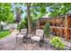 Charming backyard patio with flagstone, mature trees, and comfortable seating, perfect for outdoor relaxation at 6112 Alkire Ct, Arvada, CO 80004