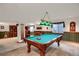 Finished basement with pool table, natural light, and ample space for entertainment at 6112 Alkire Ct, Arvada, CO 80004