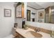 Cozy bathroom vanity with framed mirror and coordinated wall decorations at 6112 Alkire Ct, Arvada, CO 80004