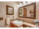 Bathroom with decorative mirrors, sink, and neutral colors at 6112 Alkire Ct, Arvada, CO 80004