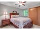 Cozy bedroom featuring a wooden bed frame, a ceiling fan, and a side table lamp at 6112 Alkire Ct, Arvada, CO 80004