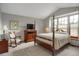 Comfortable bedroom with a large window, neutral paint, and sitting area at 6112 Alkire Ct, Arvada, CO 80004