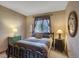 Comfortable bedroom with natural light, decorative wall art and pillows, and a bedside table at 6112 Alkire Ct, Arvada, CO 80004