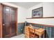 Bright bedroom featuring desk, guitar, wood trim and paneled door at 6112 Alkire Ct, Arvada, CO 80004