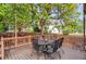 Wooden deck with seating and string lights hung from tree above at 6112 Alkire Ct, Arvada, CO 80004