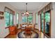 Bright dining area with wood floors, large windows, and sliding door to outdoor deck at 6112 Alkire Ct, Arvada, CO 80004
