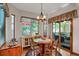 Cozy dining area with natural light, wood floors, and access to outdoor space at 6112 Alkire Ct, Arvada, CO 80004