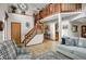 Grand foyer with staircase, wood railings, and tile flooring, creating an inviting entrance at 6112 Alkire Ct, Arvada, CO 80004