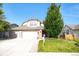 Charming two-story home with brick accents, well-manicured lawn, mature tree, and a spacious driveway at 6112 Alkire Ct, Arvada, CO 80004