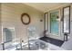 Inviting front porch with rocking chairs, seasonal wreaths, and decorative lanterns at 6112 Alkire Ct, Arvada, CO 80004
