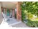 Charming front porch with rocking chairs, brick pillar, lovely landscaping and a decorative water feature at 6112 Alkire Ct, Arvada, CO 80004
