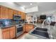 Spacious kitchen with granite countertops, stainless steel appliances, and an open layout at 6112 Alkire Ct, Arvada, CO 80004