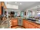 Open kitchen with granite countertops, stainless steel appliances, and views into the living area at 6112 Alkire Ct, Arvada, CO 80004