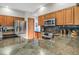 Spacious kitchen featuring granite countertops, stainless steel appliances, and ample wood cabinetry at 6112 Alkire Ct, Arvada, CO 80004