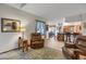 Cozy living room featuring tile floors, a large leather armchair, and view to kitchen at 6112 Alkire Ct, Arvada, CO 80004