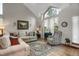 Bright living room with high ceilings, large windows, plush seating, and stylish décor at 6112 Alkire Ct, Arvada, CO 80004